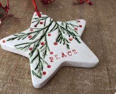 a ceramic star ornament with the word peace painted on it