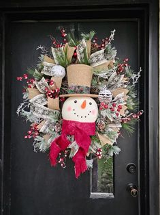 a christmas wreath with a snowman on it