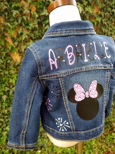 This Minnie Mouse Denim Jacket features lightweight and comfortable denim construction, perfect for everyday wear. It is custom designed with black, pink, and white colors to create a festive and stylish look, with rhinestones and name added for an extra special touch. Make a statement in this custom Minnie Mouse Jean Jacket. These jackets run TRUE TO SIZE. Please note that jackets are personalized and made to order. They will not always be exact replicas. Denim color may vary. Minnie Mouse Jean Jacket, Minnie Mouse Silhouette, Customised Denim Jacket, Custom Jean, Custom Jean Jacket, Lightweight Denim Jacket, Custom Barbie, Girls Denim Jacket, I Love My Daughter