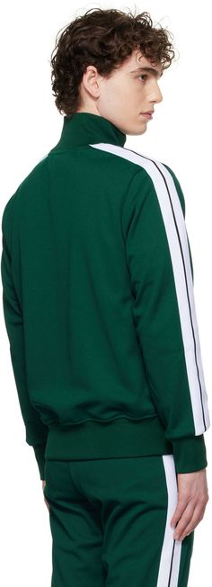 Polyester jersey track jacket. · Rib knit stand collar, cuff, and hem · Zip closure · Logo printed at chest · Zip pockets · Stripe trim at sleeves · Full jersey lining Supplier color: Green/White Sports Track Jacket With Ribbed Cuffs And Long Sleeves, Sporty Green Track Jacket With Ribbed Cuffs, Green Sporty Track Jacket With Ribbed Cuffs, Sporty Long Sleeve Track Jacket With Elastic Cuffs, Sporty Track Jacket With Elastic Cuffs, Sportswear Track Jacket With Contrast Stripes, Casual Track Jacket With Contrast Stripes, Athleisure Long Sleeve Track Jacket With Ribbed Cuffs, Fall Track Jacket With Side Stripes And Long Sleeves