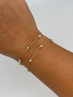 A dainty take on a pearl bracelet. Gold beads float freely in between dainty pearls. 1" extender 14k gold fill made in Los Angeles pearls vary in shape and size Sizes Small - 15cm or 6" Medium - 16cm or 6.5" Large - 17cm or 7" Dainty Adjustable Beaded Bracelets With Pearl Chain, Minimalist Adjustable Pearl Bracelet With Extender, Everyday Minimalist Pearl Bracelet With Extender, Dainty Adjustable Pearl Bracelet, Delicate Adjustable Pearl Bracelet, Dainty Gold Bracelets With Pearl Chain, Dainty Gold Pearl Bracelet With Pearl Charm, Adjustable Minimalist Pearl Bracelet, Minimalist Adjustable Pearl Chain Bracelet