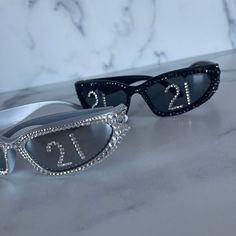 two pairs of sunglasses with numbers on them