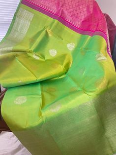 Traditional Kili pachchai (Parrot green) and rani pink turning border kanjeevaram silk saree. The body is a beautiful dual tone of parrot green with alternating motifs of silver and gold zari butta. Turning border is a unique technique of weaving where the border design is enhanced and looks so beautiful .Comes with a contrast Rani pink pallu and an unstitched  blouse. Saree width : 49 inches Maintenance: Dry wash advisable Returns and refund only accepted on defective products. Product should b Multicolor Banarasi Silk Dupatta With Tilla, Green Handloom Raw Silk Traditional Wear, Green Raw Silk Handloom Traditional Wear, Green Wedding Saree With Tilla Work, Green Wedding Saree With Tilla Details, Multicolor Paithani Silk Saree With Tilla, Multicolor Paithani Silk Saree With Tilla Details, Green Tussar Silk Saree For Festivals, Green Raw Silk Traditional Wear For Puja