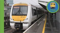 a yellow and white train pulling into a station with the words thu on it