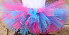 "A stunning, fluffy pink, purple, and blue tutu All tutus are made with high quality tulle and a 1\" non-roll waist band.  I make all my tutus very full and fluffy.  I put as much tulle as I can possibly fit. Each tutu has a matching bow attached. When measuring your child's waist, order the size that is 2 inches smaller than her actual waist since the band is made of elastic. Tutu Size Chart 0-6 mo         14\" waist    6\"length 6-12 mo       15\"waist     6\"length 12-24 mo     16\"waist Multicolor Tulle Tutu Dress For Wedding, Multicolor Tulle Tutu Dress, Blue Tulle Skirt Tutu Dress For Birthday, Cute Purple Tulle Tutu Dress, Purple Tulle Tutu Dress For Birthday, Purple Tutu Dress For Summer Dress-up, Purple Tulle Tutu Dress With Ruffles, Playful Purple Tutu Dress For Birthday, Pink Blue Tutu