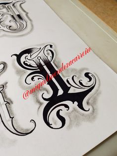 some type of art work on paper with black and white ink, in the shape of letters