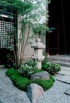 a small garden with rocks and grass