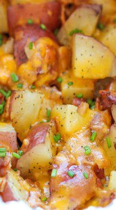 a white plate topped with potatoes and bacon