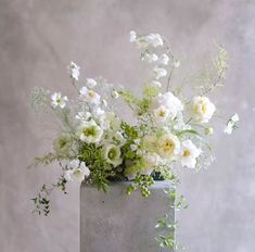 a vase filled with white flowers on top of a table