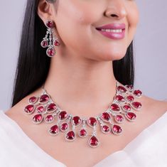 Elevate your bridal wedding elegance with Agulka Jewels' exquisite Ruby Necklace, adorned with dazzling Red Diamonds and delicate Pink Sapphires. This American Diamond Necklace Set captures the rich heritage of India's jewelry tradition, adding opulence and sophistication to your special day ensemble. Trust Agulka Jewels to make your wedding attire truly unforgettable with this stunning India-inspired jewelry, celebrating timeless beauty and culture. *𝐏𝐑𝐎𝐃𝐔𝐂𝐓 𝐃𝐄𝐓𝐀𝐈𝐋* * Material: Brass * Plating: White Rhodium Plated * Stone: AAA Quality CZ Diamon & Ruby. *𝐃𝐈𝐌𝐄𝐍𝐒𝐈𝐎𝐍𝐒* *Necklace* * Weight:  107 gm  * Length: 8.2 Inches * Drop Length: 5.7 Inches * Width: 2.2 Inches *Earrings* * Weight: 10 gm Each * Length:  2.25 Inches * Width: 1.5 Inches * Closure: Push Back *𝐒𝐇𝐈𝐏? Elegant Red Kundan Bridal Necklace, Formal Festive Crystal Necklace, Elegant Red Kundan Necklace For Reception, Elegant Kundan Necklace With Ruby For Reception, Elegant Red Kundan Necklace For Wedding, Formal Diamond Bridal Necklace With Meenakari, Red Ruby Bridal Necklace For Reception, Festive Gemstone Jewelry Sets For Party, Red Jewelry Sets For Formal Festivals