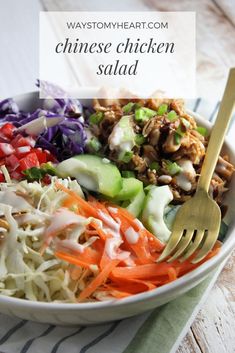 a close up of a bowl of food with carrots, celery and chicken