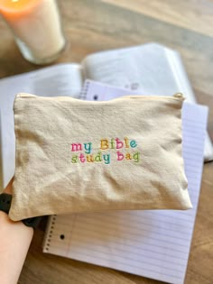 a small bag with the words my bible study bag written on it next to a candle