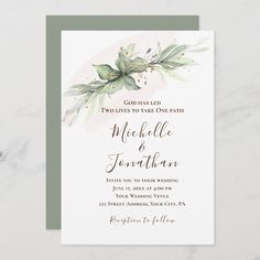 an elegant wedding card with watercolor leaves and greenery on the front, in white