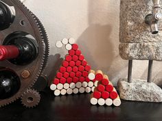 there is a small christmas tree made out of wine bottles and corks on the table