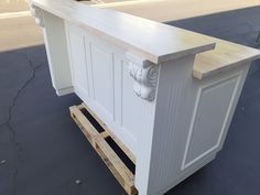 a white counter sitting on top of a wooden pallet