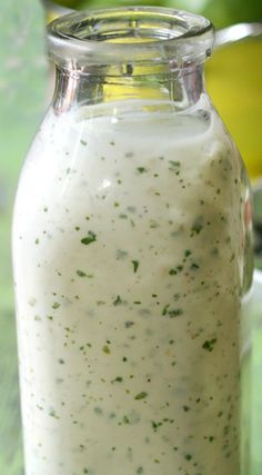 a jar filled with white liquid sitting on top of a table