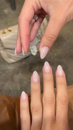 two hands with pink and white manicures holding onto each other's fingers