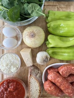 ingredients to make sausage and spinach salad laid out on a cutting board