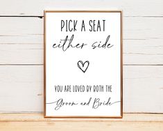 a sign that says pick a seat either side you are loved by both the groom and bride