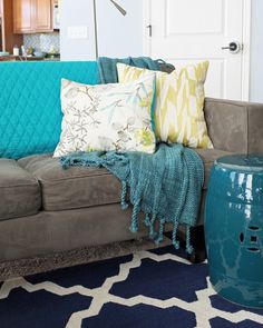 a living room filled with furniture and pillows