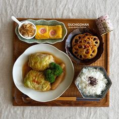 a wooden tray topped with different types of food