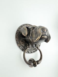 a metal hook with a dog's head on it and a ring in the middle