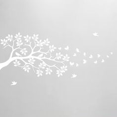 a tree with white leaves blowing in the wind on a gray background wall decal