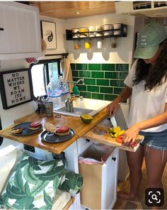 a woman is cutting fruit in the kitchen