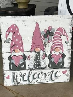 a welcome sign with gnomes on it