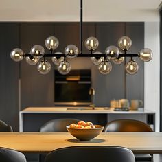 a dining room table with a bowl of fruit on it