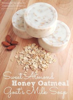 three soap bars sitting on top of a wooden table next to almonds and oats