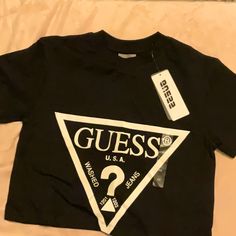 Guess Crop T-Shirt Black Guess Logo Nice New Size Xsmall Bundle Your Items To Save On Shipping! Box-A4 Logo Fitted Crew Neck Top, Fitted Logo Top With Short Sleeves, Fitted Short Sleeve Tops With Logo, Casual Short Sleeve Logo Top, Trendy Black Tops With Logo, Black Logo Top With Short Sleeves, Trendy Black T-shirt With Logo, Black Fitted Tops With Logo, Black Graphic Tee With Logo