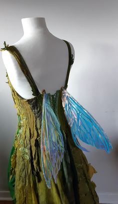 a green dress with blue wings on it