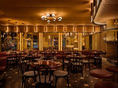 an empty restaurant with many tables and chairs