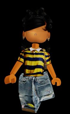 the doll is wearing shorts and a striped shirt with an earring on it's head