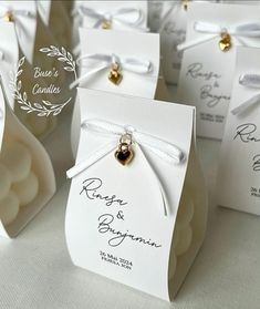 small wedding favors with gold bells and ribbons