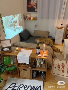 a bedroom with a bed, desk and shelves filled with bottles of wine on the floor