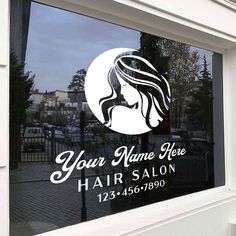 a hair salon sign on the side of a window