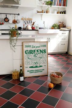 a kitchen with red and black tile flooring next to a sign that says greens