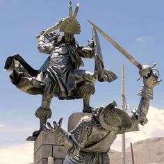 a statue of a man holding two swords