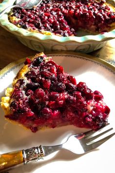 a piece of pie with cranberry sauce on it and a fork next to it