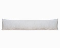 the linen pillow is white and has a long, rectangular design on top of it