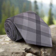 Introducing our silk luxury grey and black necktie, an exquisite accessory that effortlessly combines elegance, style, and versatility. Crafted from the finest silk, this necktie showcases a captivating plaid pattern, adding a touch of sophistication to your ensemble. The rich combination of grey and black creates a striking contrast, evoking a sense of refinement and class. The plaid pattern adds depth and texture to the necktie, lending a timeless appeal that is both modern and classic. It is Gray Standard Tie For Formal Occasions, Elegant Gray Suit And Tie Accessories For Formal Occasions, Elegant Gray Suit And Tie Accessories For Office, Elegant Gray Business Tie, Classic Gray Tie For Black Tie Events, Classic Gray Standard Tie And Suit Accessories, Classic Gray Tie For Semi-formal Occasions, Gray Ties For Business, Gray Standard Tie For Office