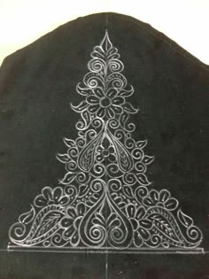 a black jacket with a white christmas tree on it