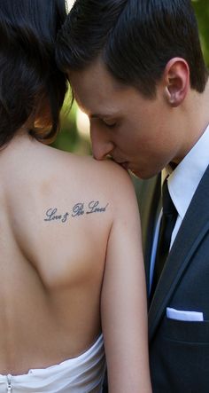 a man and woman with tattoos on their backs