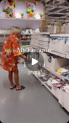 a woman is looking at some items in a store