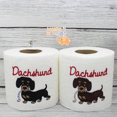 two rolls of personalized toilet paper with dachshund dogs on them for birthdays