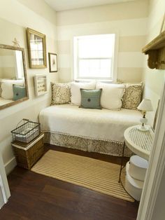 a bedroom with a white bed and pillows