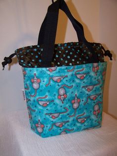 Offering a drawstring insulated Lunch Bag.  Sweet mouse design combined with black poly strap handles and brown polka dot batik drawstring top. Such a fun style design that is sure to please you. The lining is BPA free, food safe rip stop nylon in clean bright white. The rip stop nylon lining is moisture resistant and will hold spills for a limited time.The  cotton drawstring top pulls closed with black paracord and holds tight with easy open cord locks in black. Handles are sewn with triple sti Cute Blue Lunch Bag For Gift, Drawstring Lunch Bag, Cat Footprint, Cooler Food, Lunch Cooler, Brown Polka Dots, Turquoise Background, Black Handles, Insulated Lunch Box