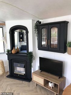 a living room with a fireplace and entertainment center